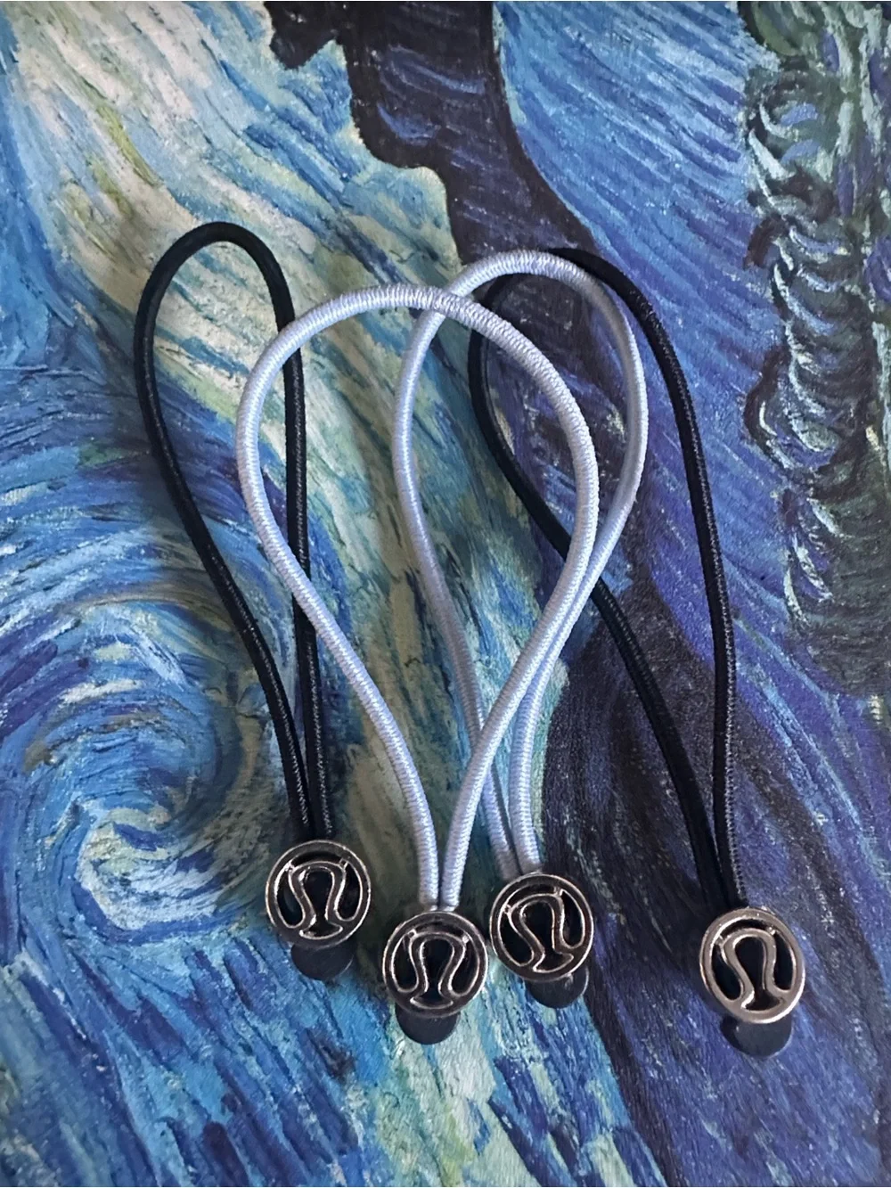 One pair black Lululemon zipper pull or Hair Ties